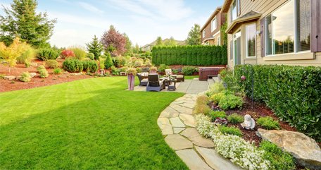 Landscape backyard with a hardscape walkway and patio